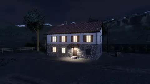 The farmhouse at night with lit windows