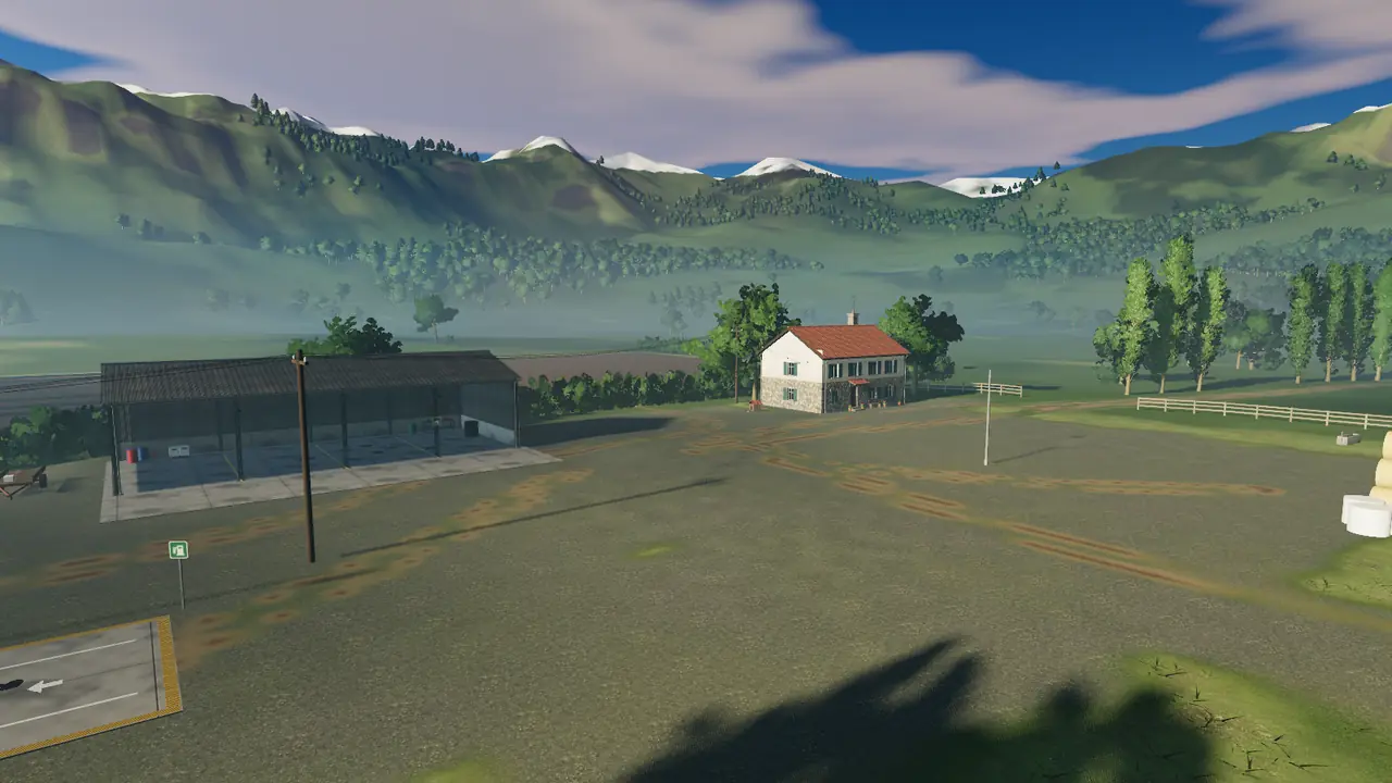 The farmhouse, shed and ploughed fields in the valley in morning light